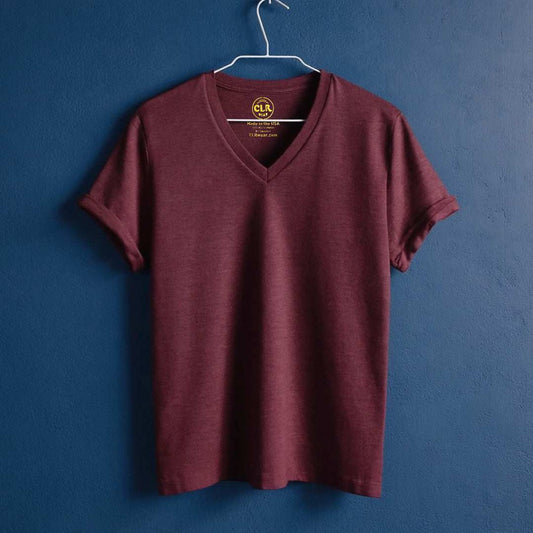 The Business Tee in maroon with V-neck and tailored fit, hanging on a hanger against a blue background.
